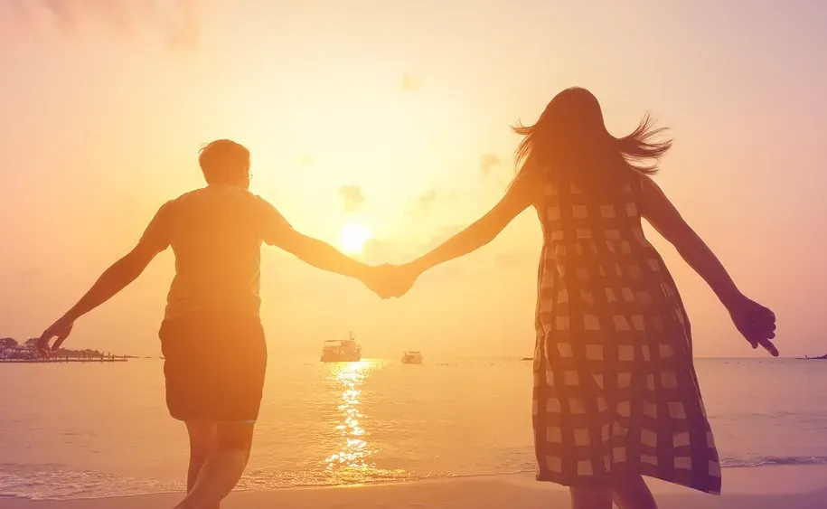 Couple Holding Hands On A Beach At Sunset — Serene Therapy with Lana In Paddington, NSW