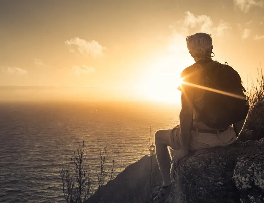 A Man Watching The Sunset From A Coastal lookout — Serene Therapy with Lana In Paddington, NSW