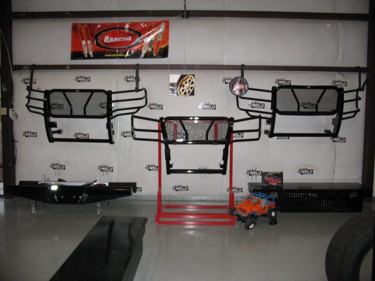 A wall with a sign that says ranger on it, showing truck grills