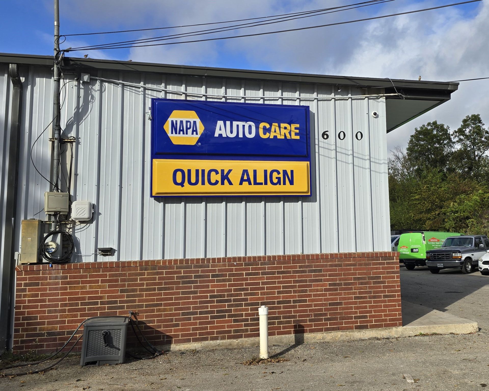 A napa auto care quick align sign is on the side of a building