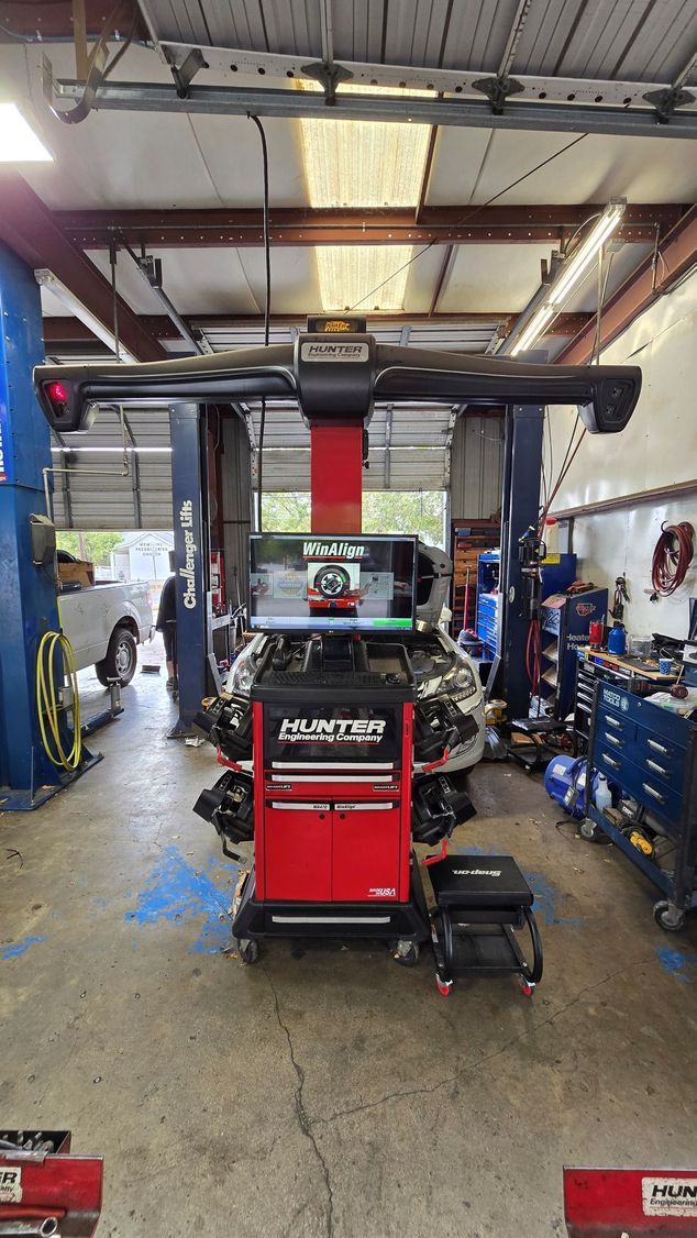 A red and black machine is sitting in a garage.