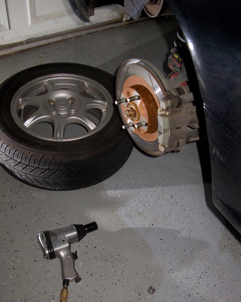 a tire is sitting on the ground next to a brake disc