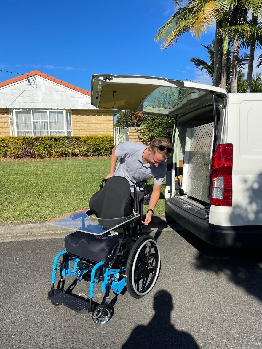 A person in a wheelchair is standing in a hallway.
