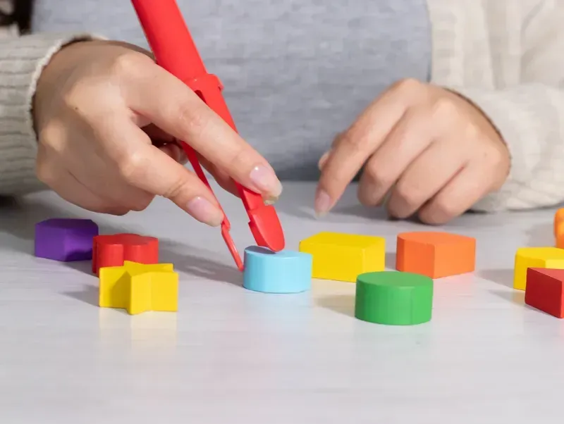 A man is working on a wheelchair in front of lockers.