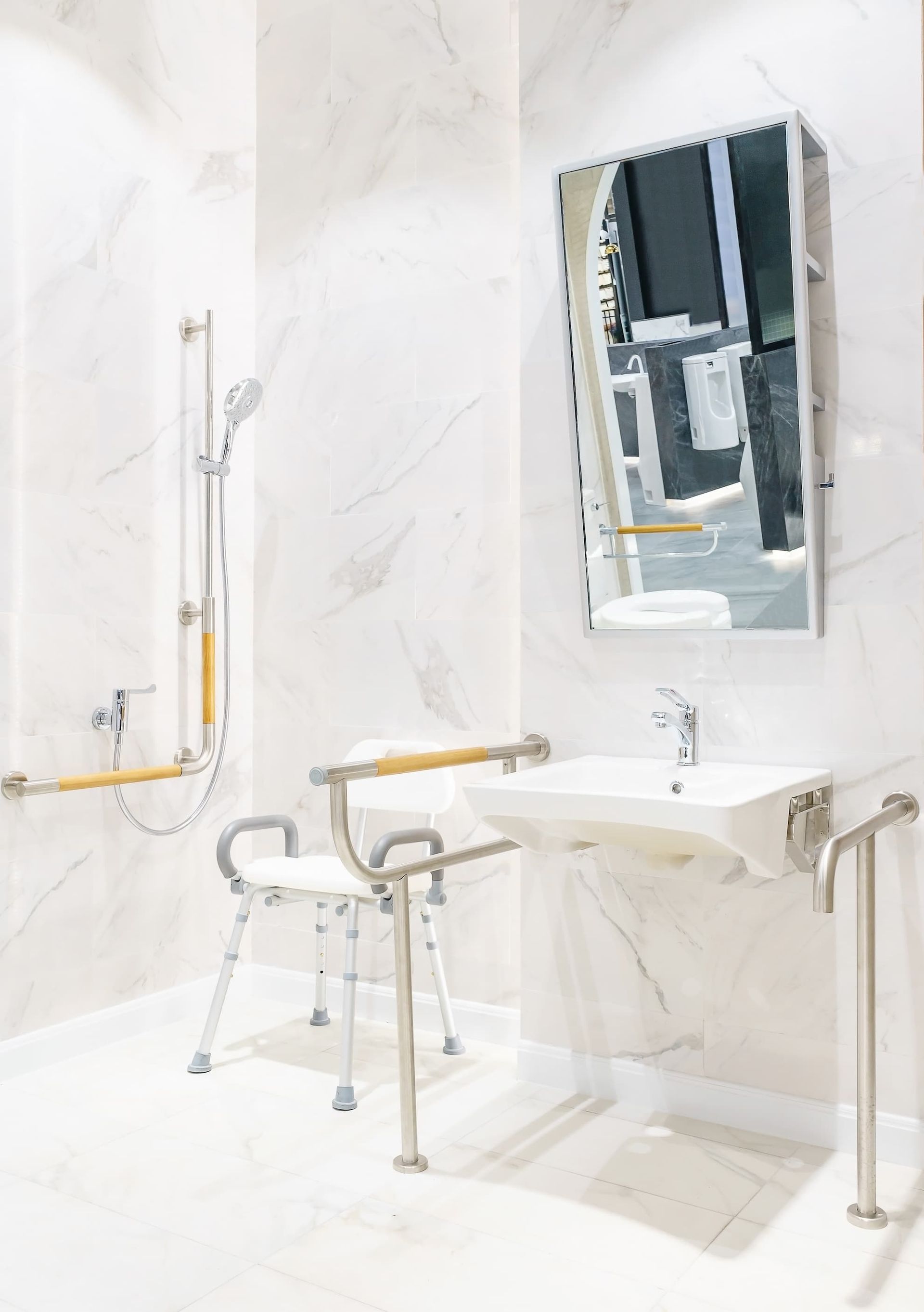 A bathroom with a sink , shower , and mirror.