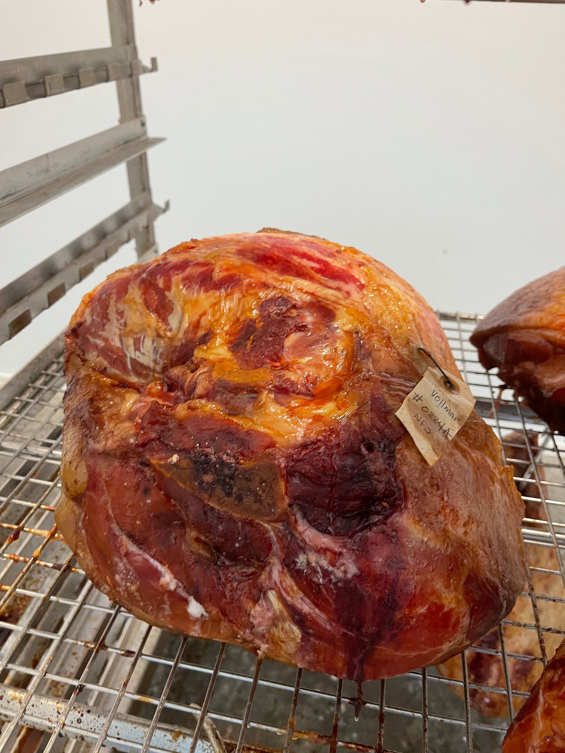 A large piece of meat is sitting on a wire rack.