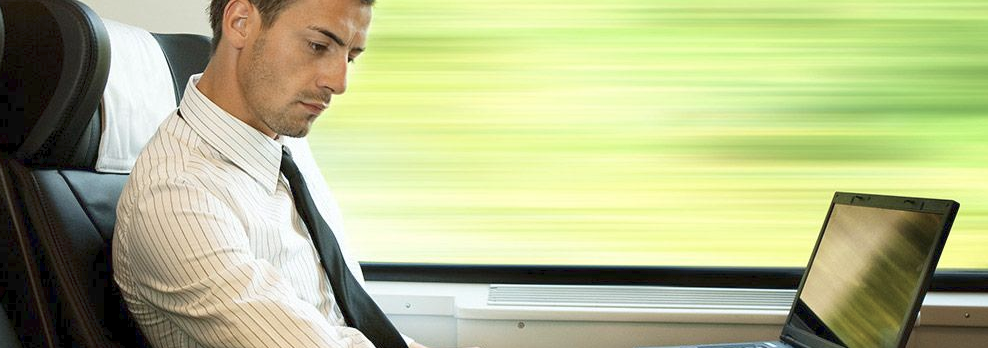 Man using a laptop on a train