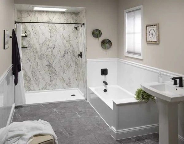 A bathroom with a bathtub , sink and shower.