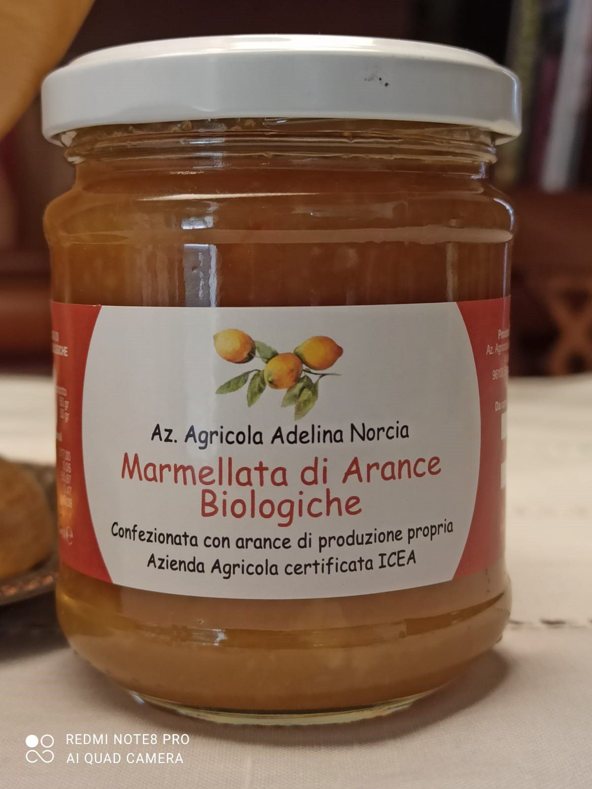 Jar of orange marmalade, white label, text: