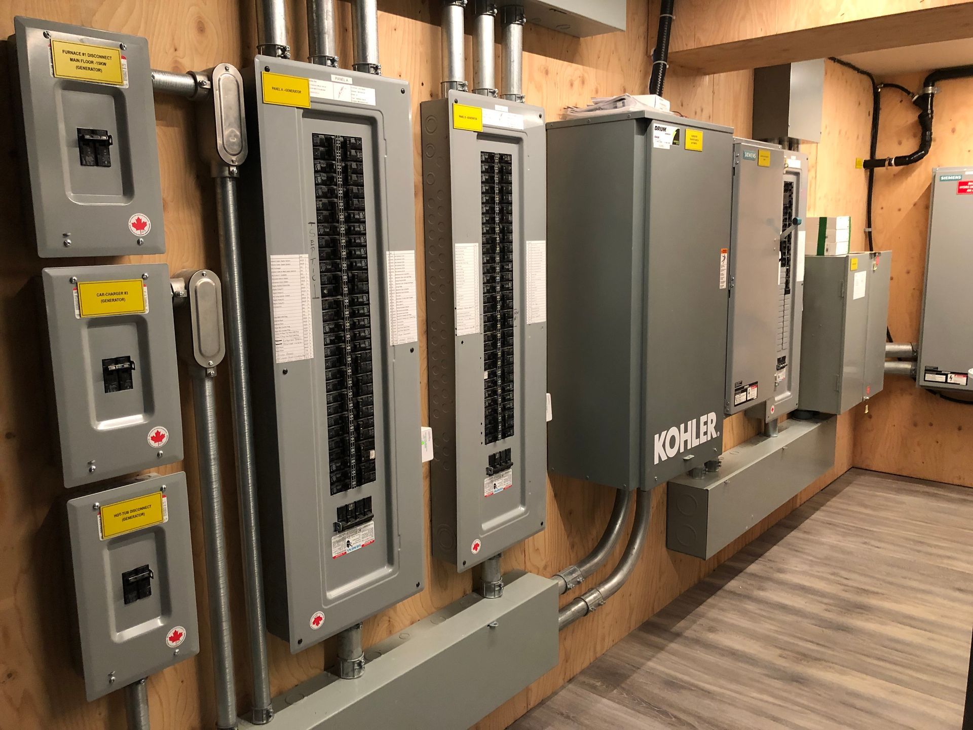 Electrical panel room with circuit breaker panels and a Kohler power generator.