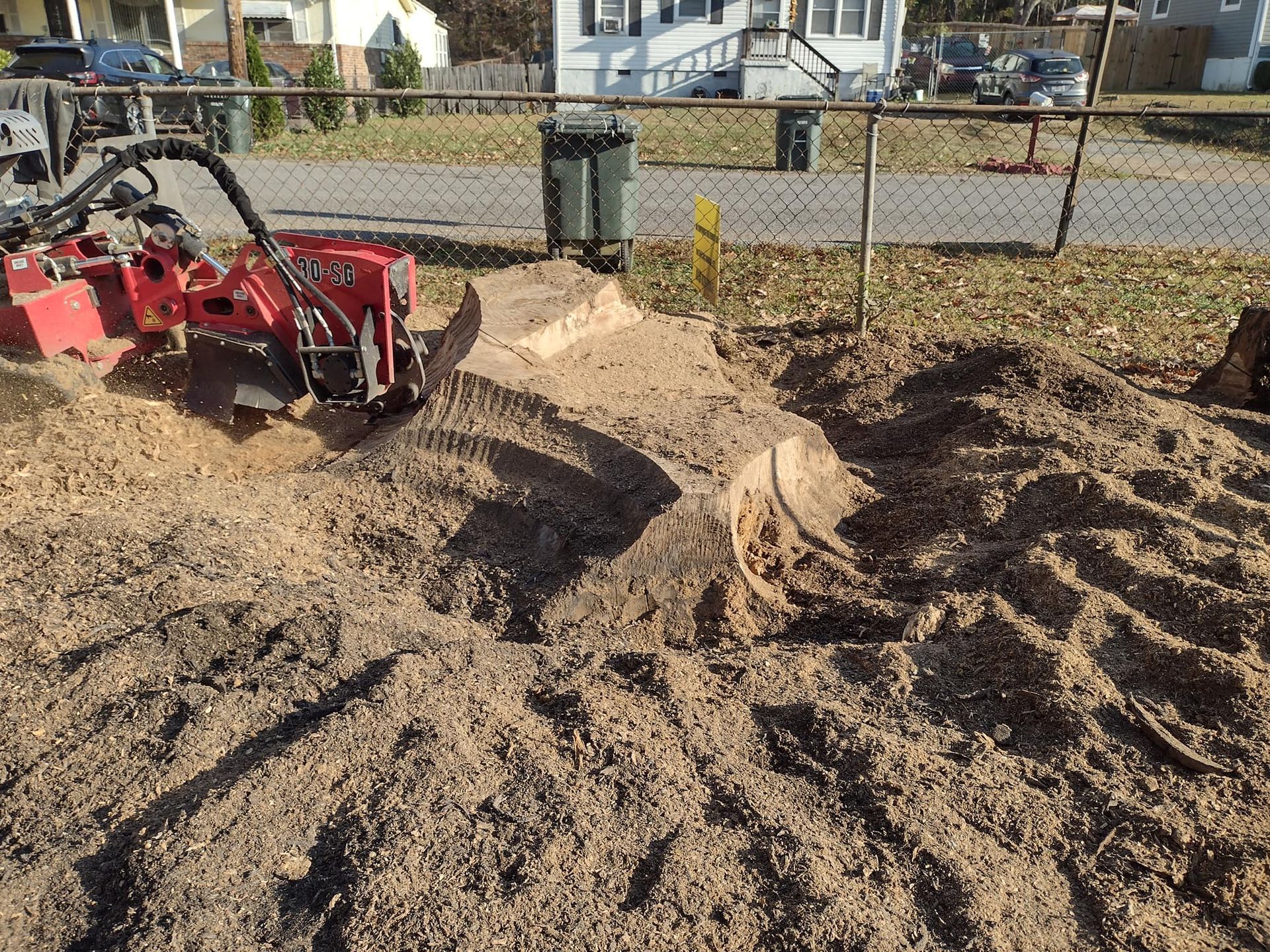 A stump grinder is being used to remove a tree stump.