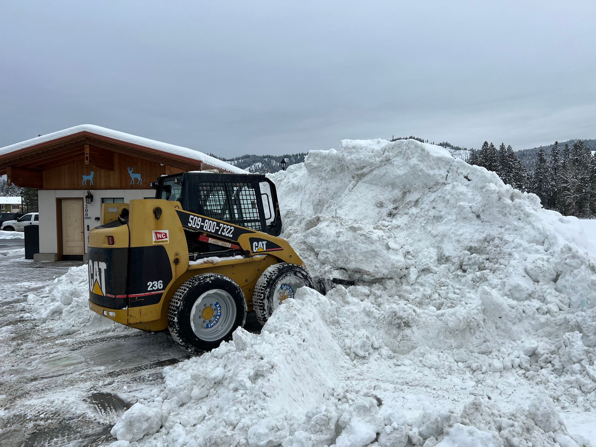 A bulldozer is clearing snow from a parking lot.