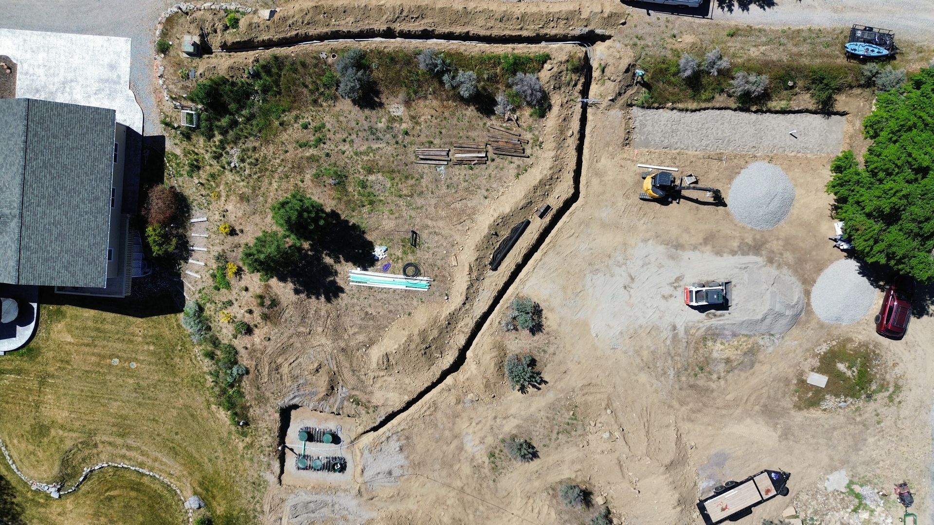 An aerial view of a house and a lot of dirt.