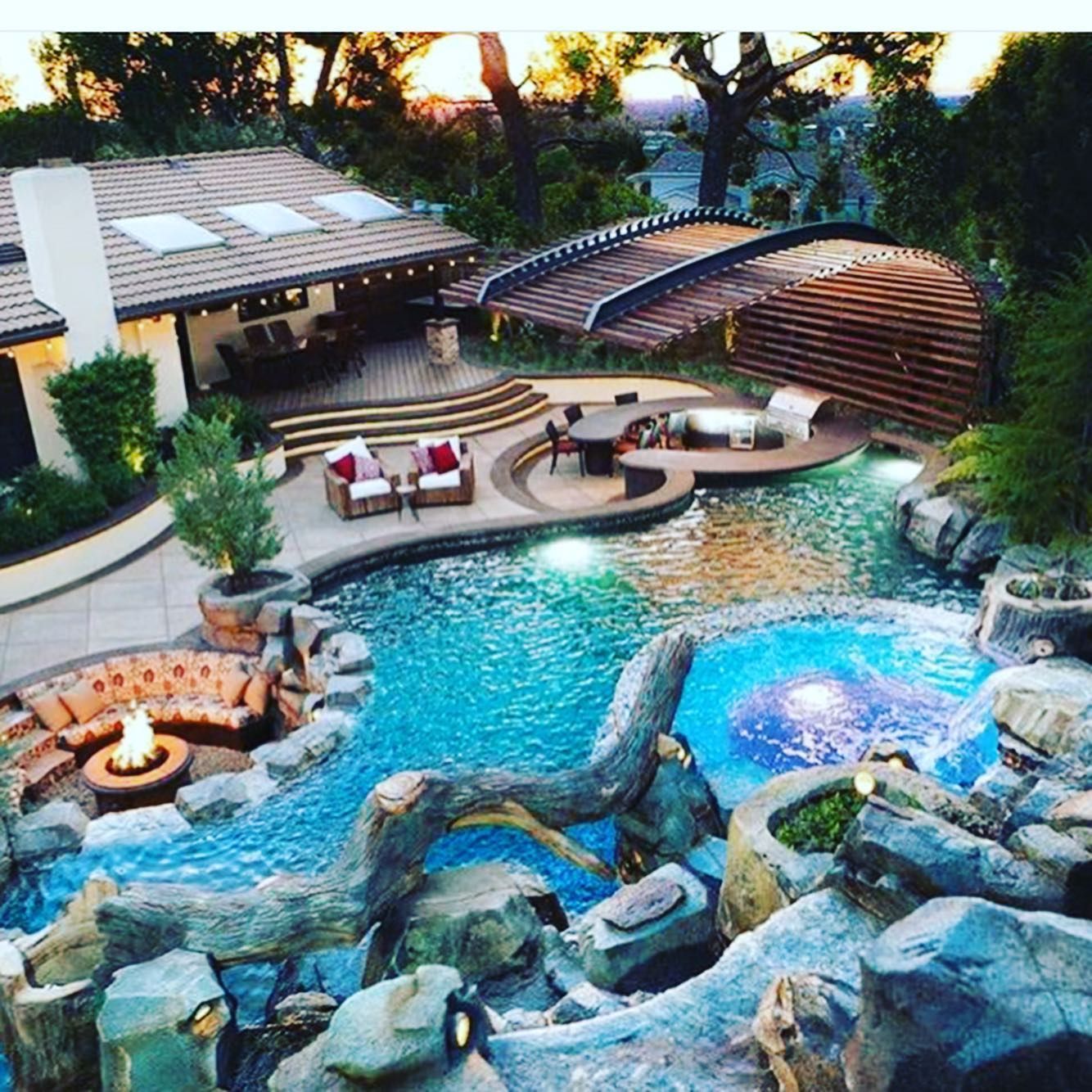 A large swimming pool with a stone wall in the background