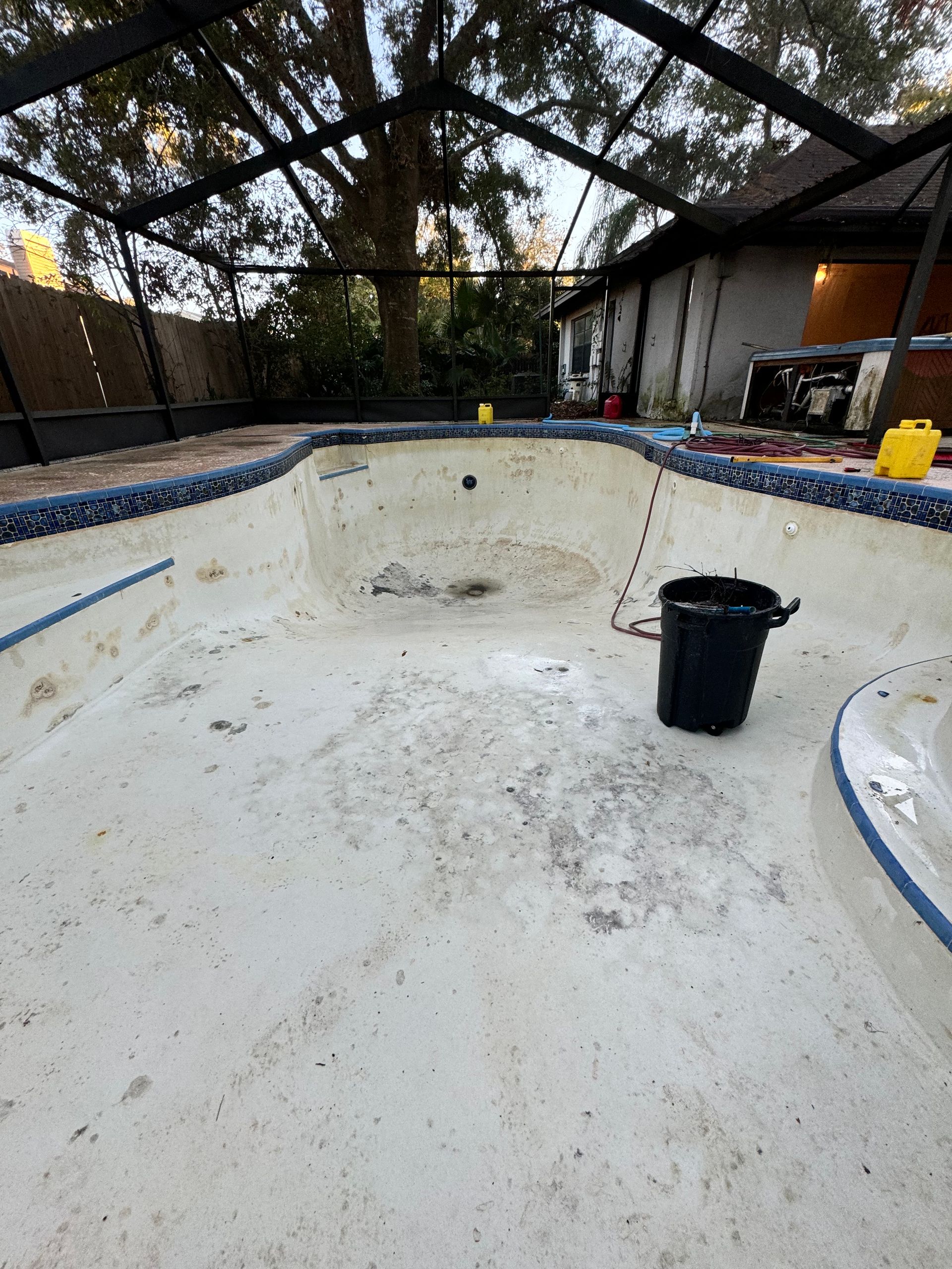 A hose is attached to the side of a swimming pool.