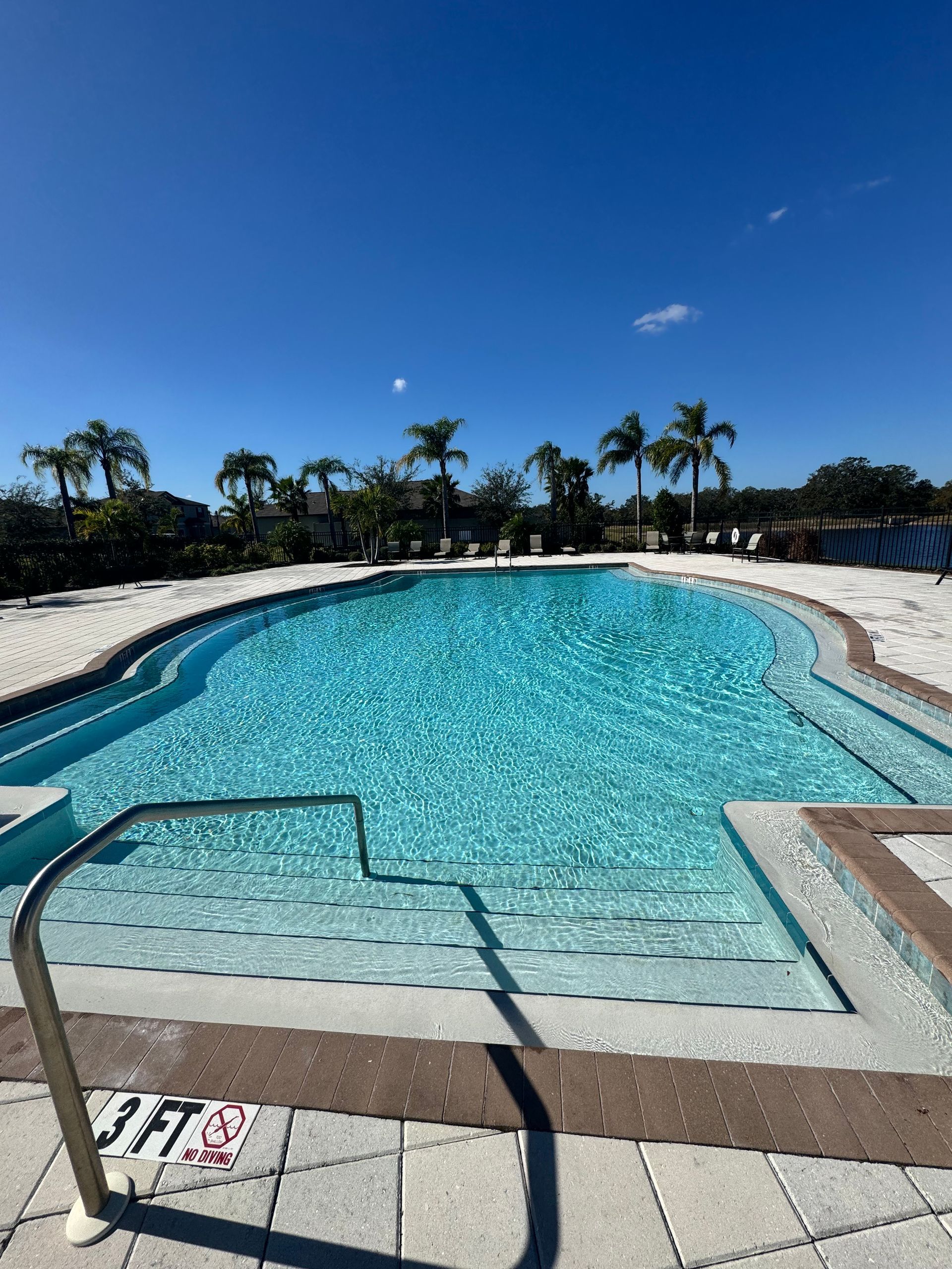 A person is holding a piece of blue tile in their hands.