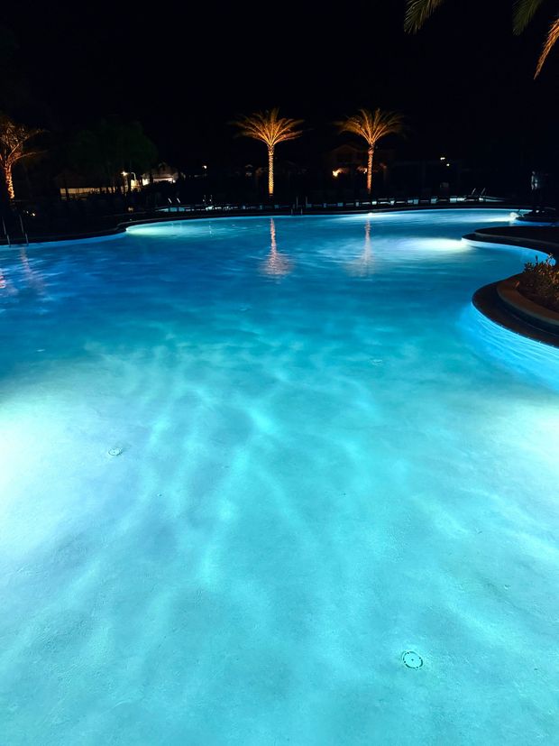 A large house with a large swimming pool in front of it