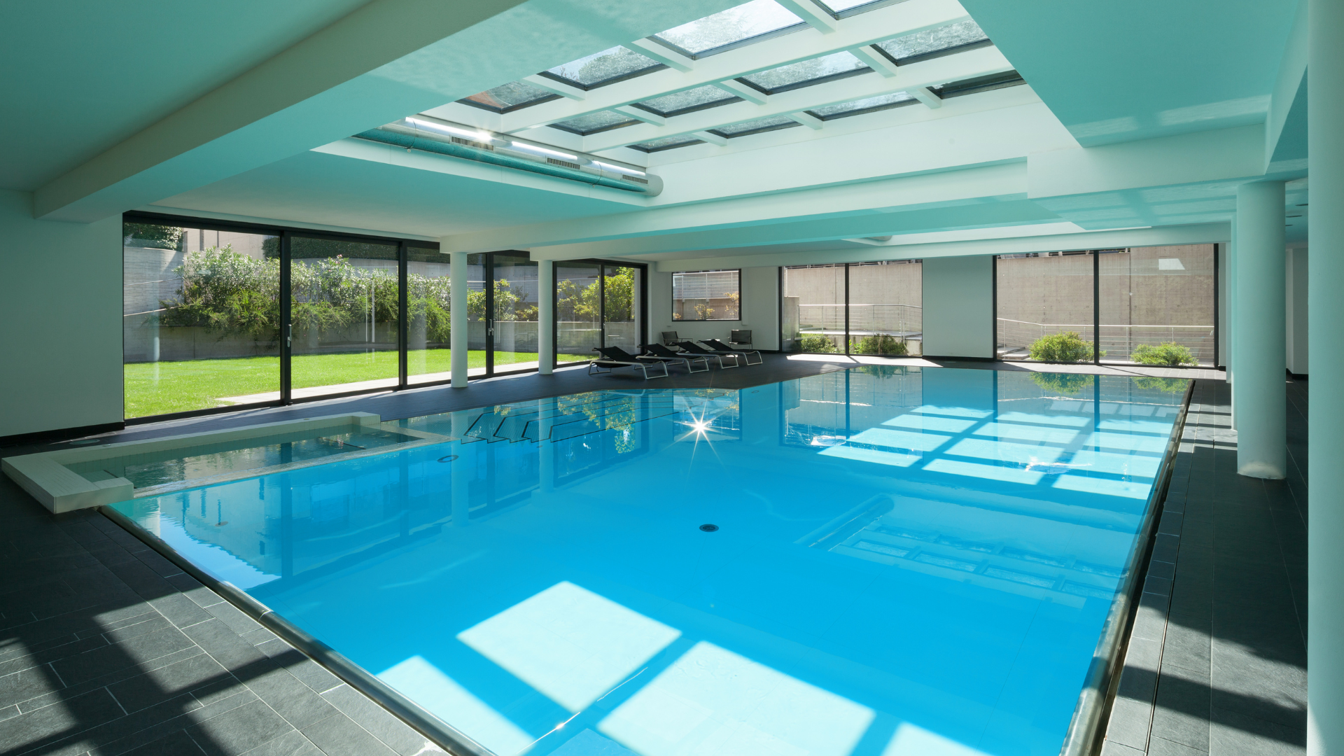 A large house with a swimming pool in front of it