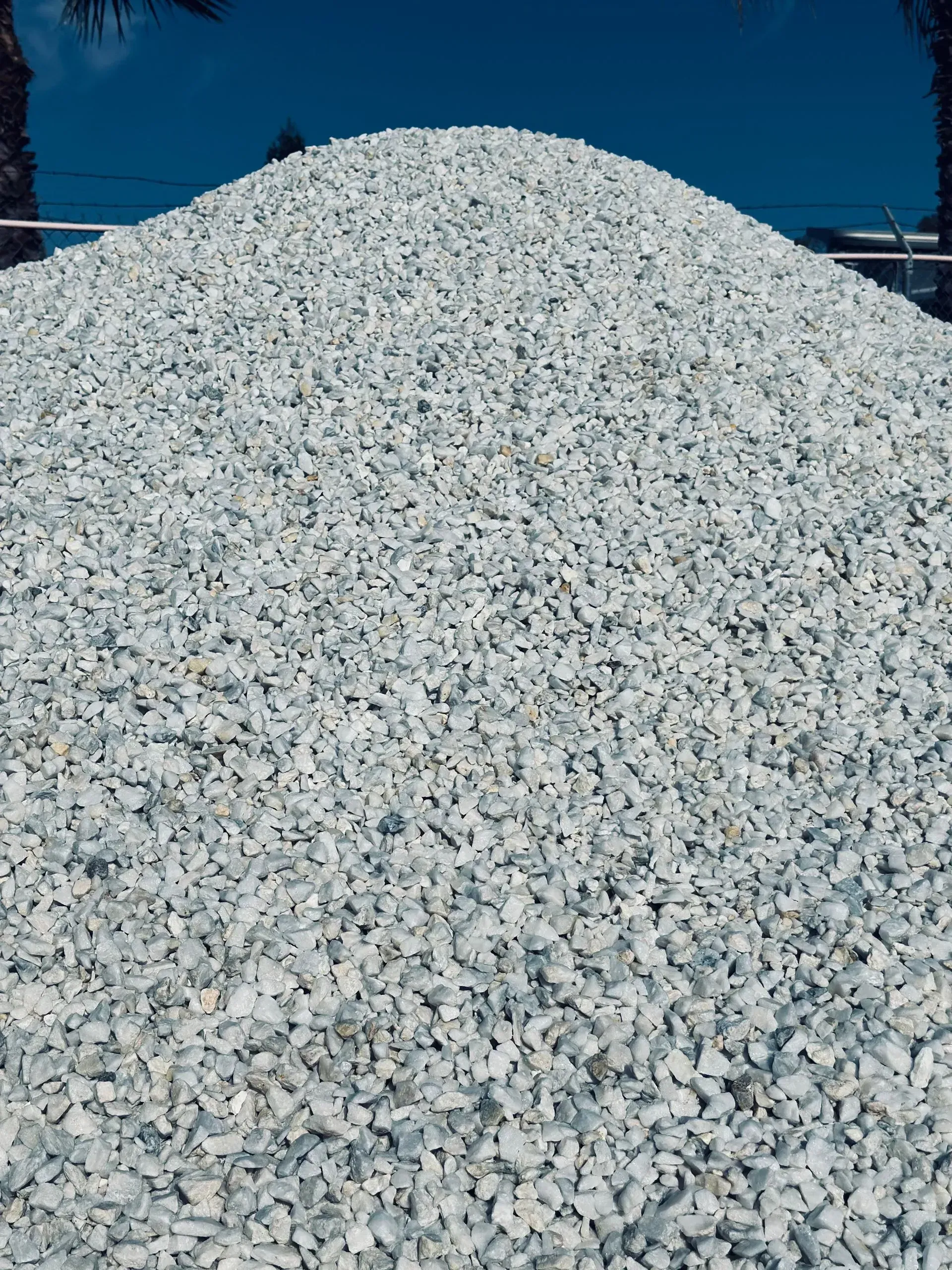 Pile of white gravel against a blue sky.
