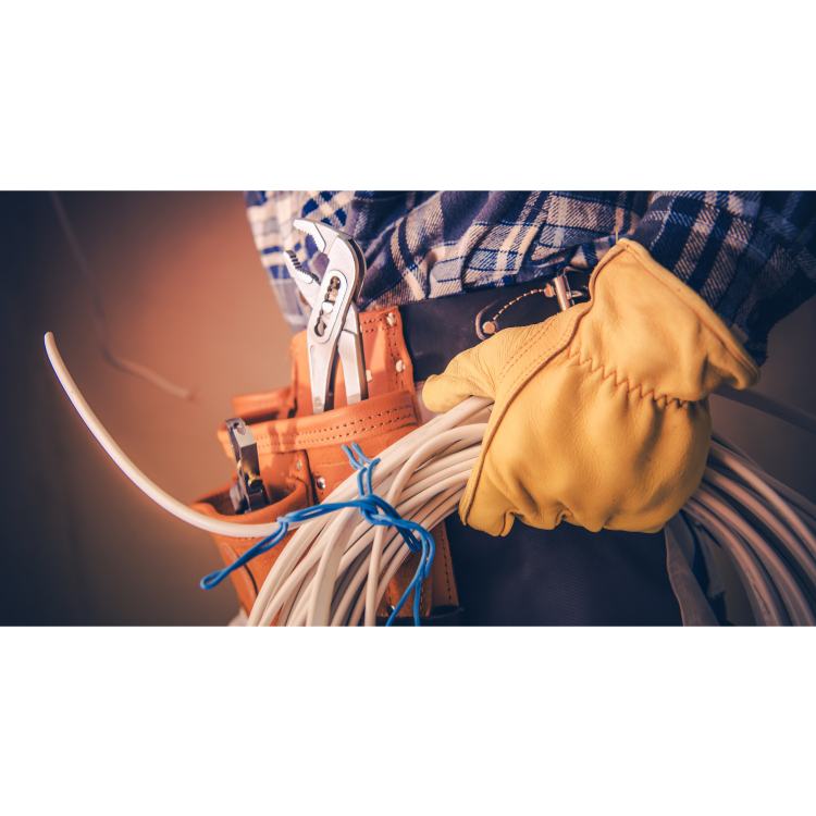 An electrician is holding a bunch of wires and a wrench.