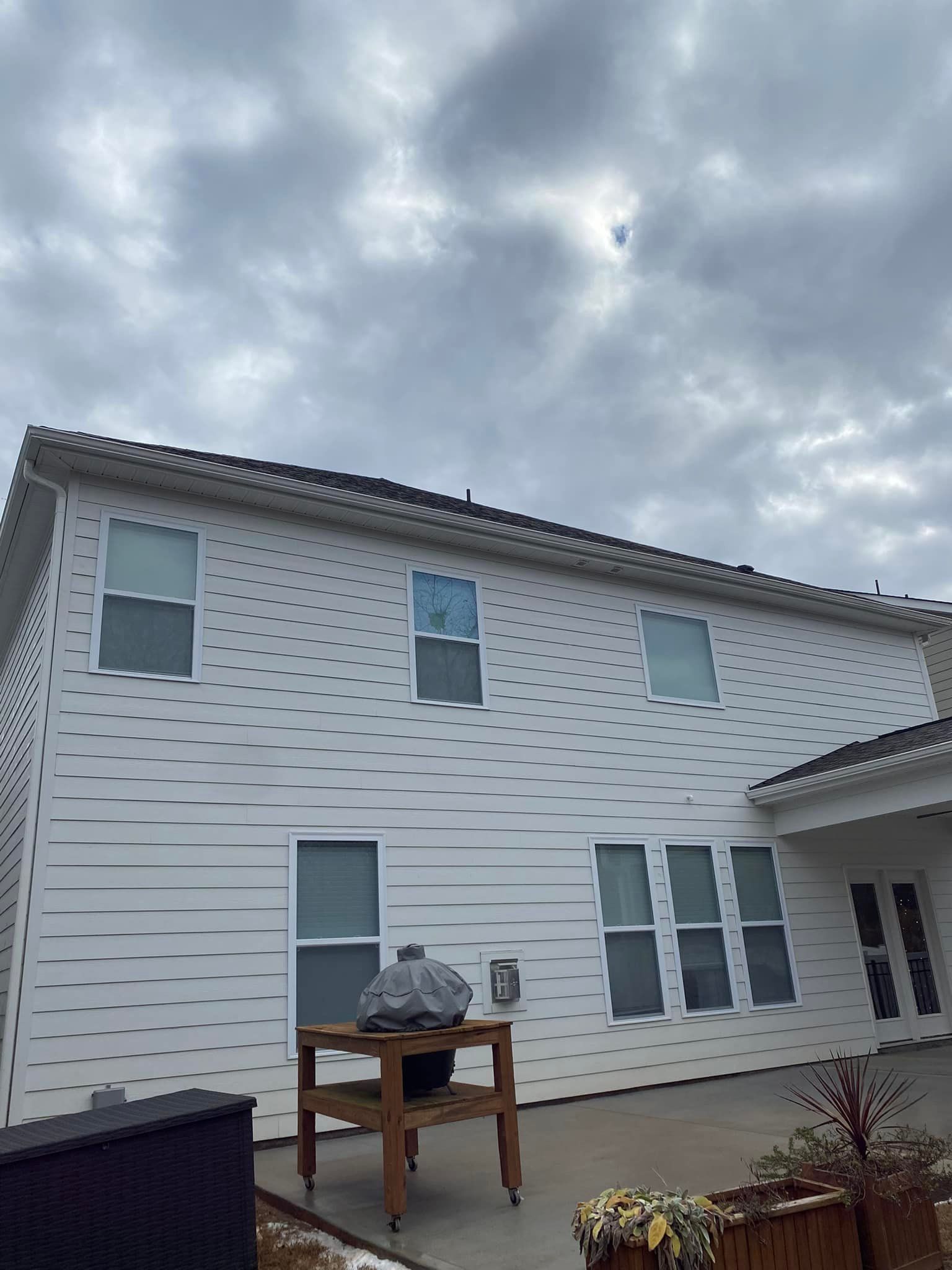 White house exterior with multiple windows, cloudy sky overhead.