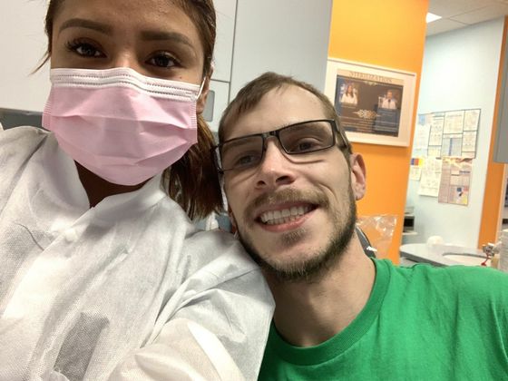 Denture Patient smiling beside doctor with mask on