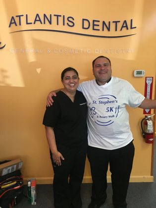 patient with dentist posing for picture