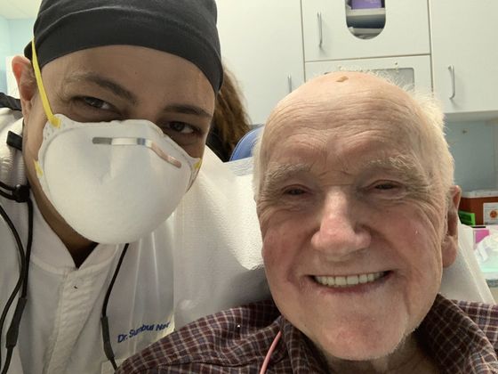 old male patient smiling with dentist