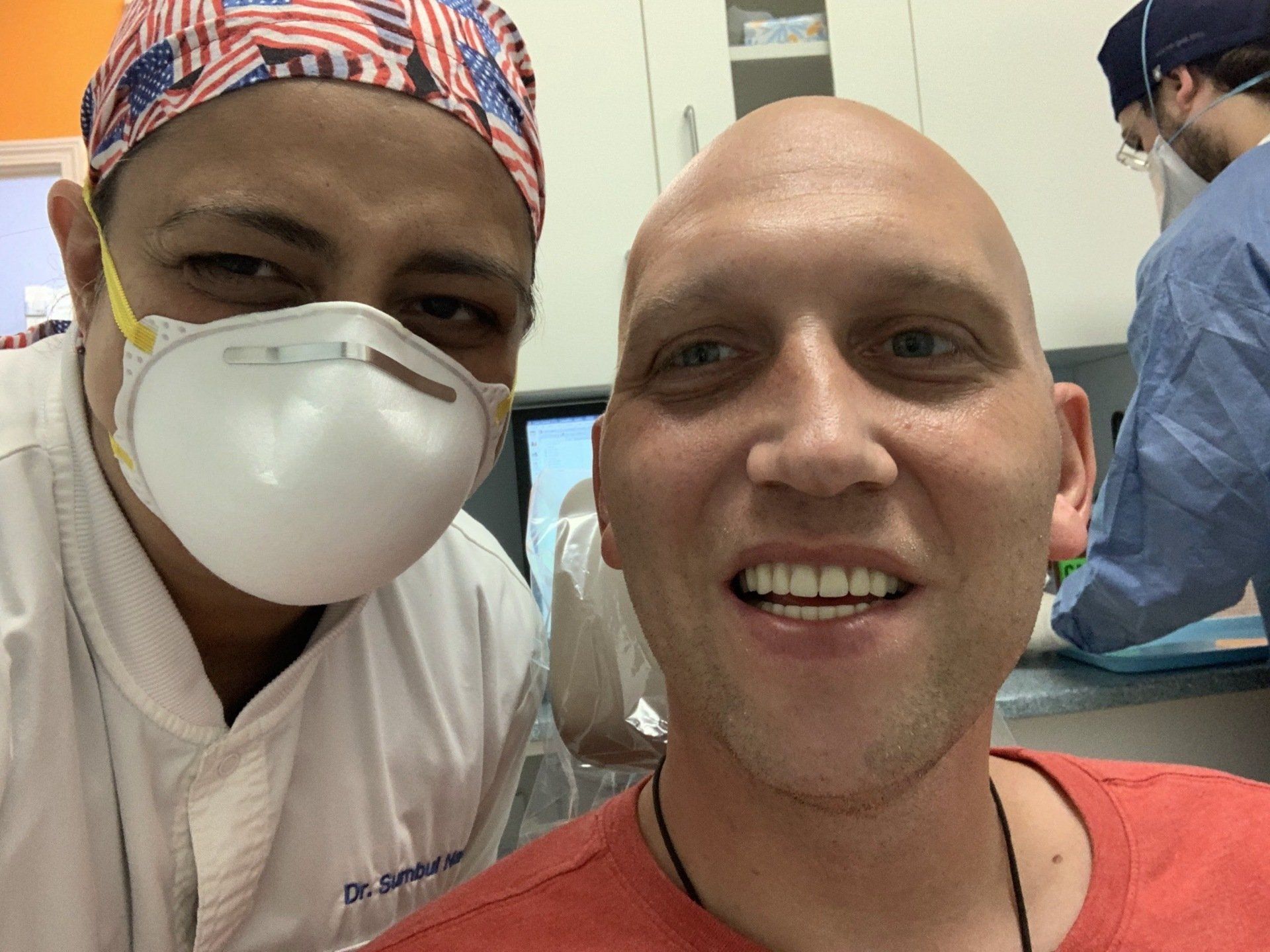 white male patient smiling with dentist