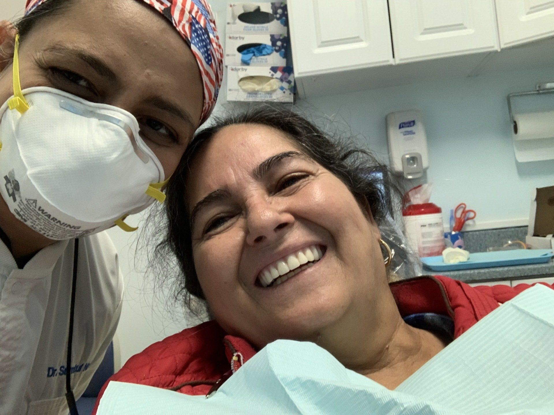 old female patient smiling with dentist