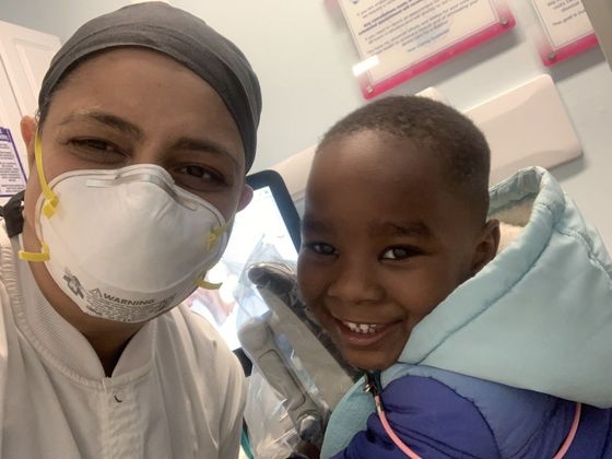 little african boy smiling with dentist