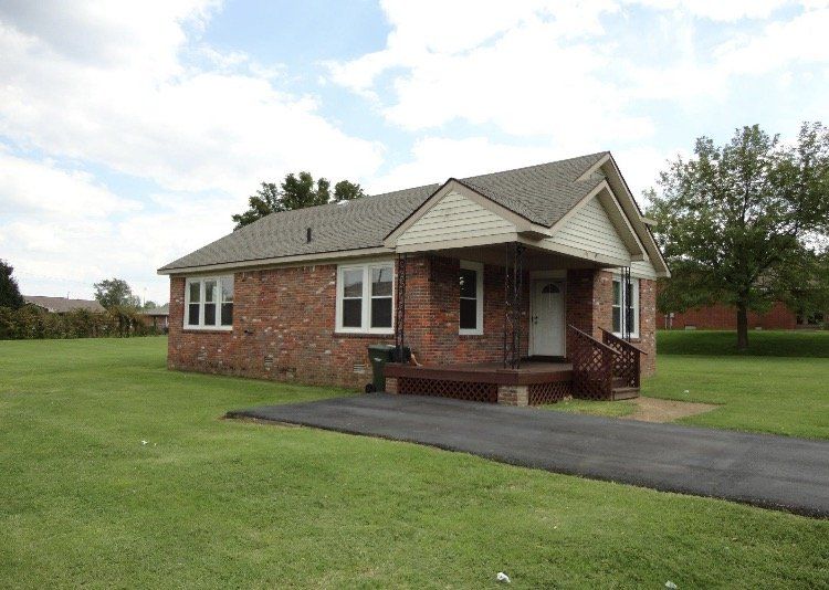 brick house with paved driveway