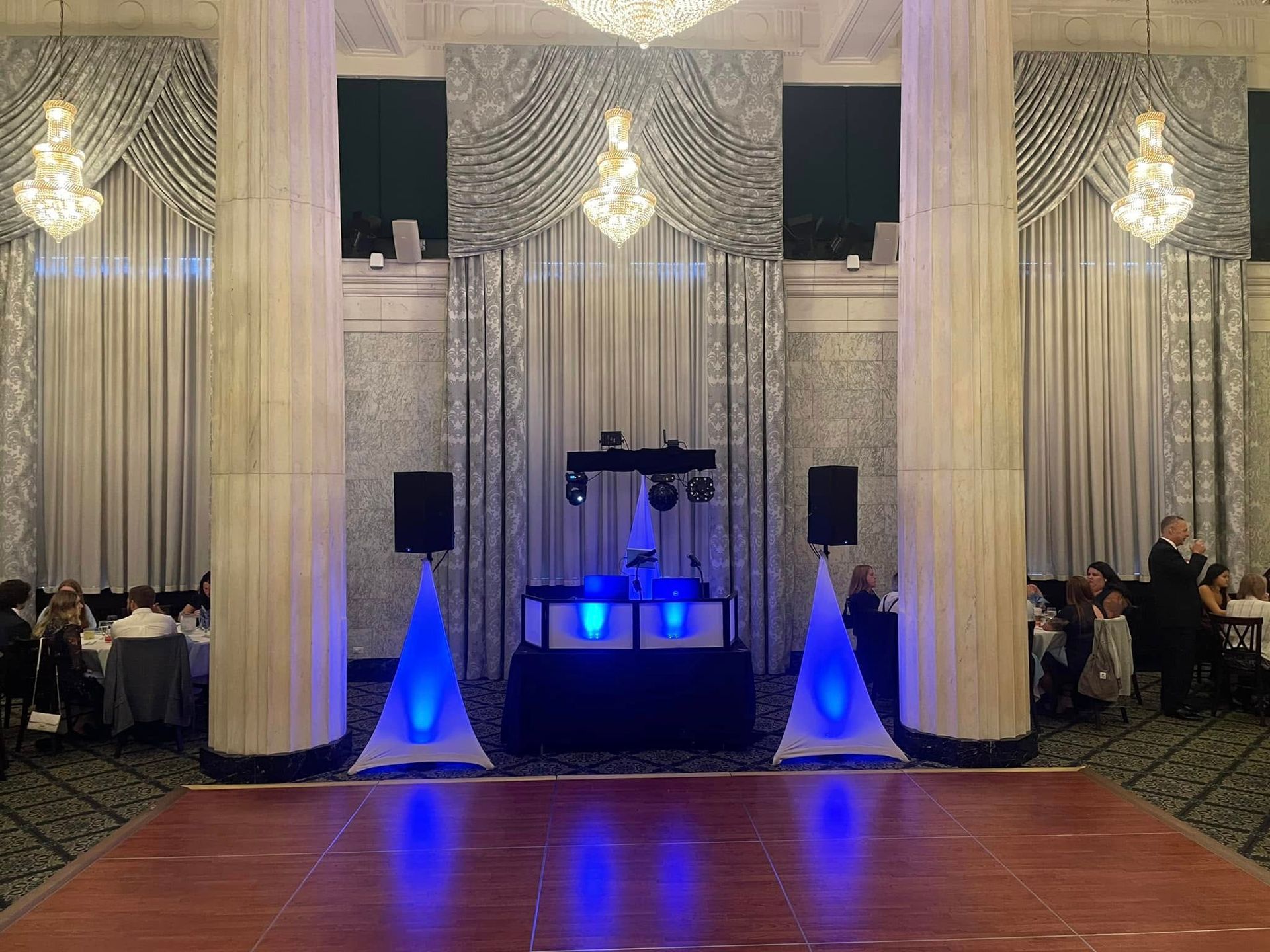 Stage spotlights, arranged on black framework, illuminating outdoors with blue sky background.