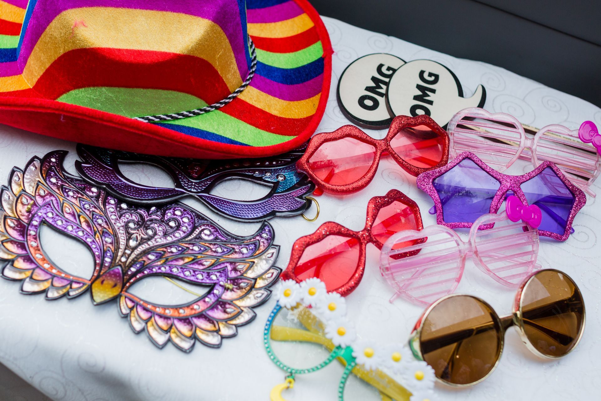 Colorful party accessories: hat, masks, sunglasses, and 