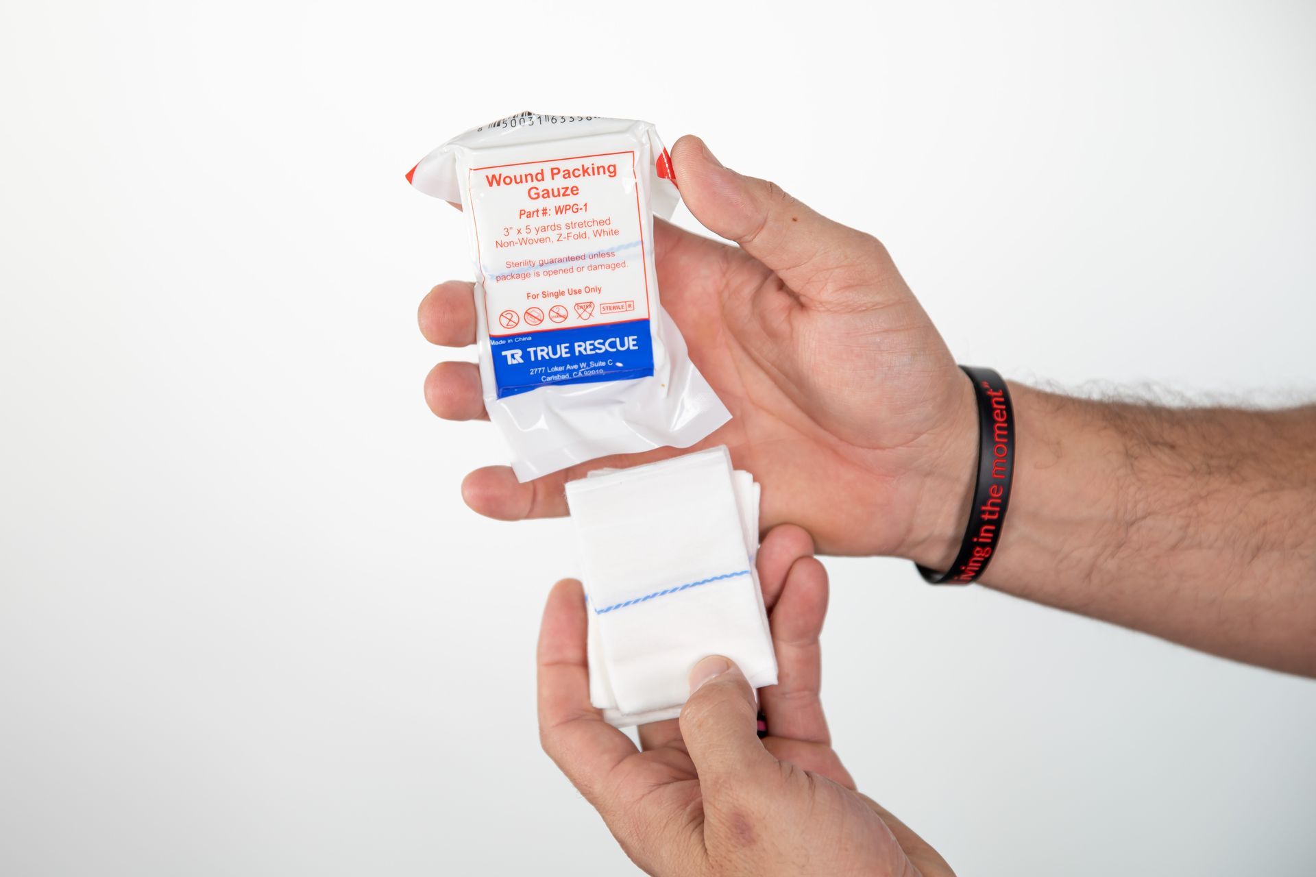 A first aid kit is sitting on a wooden table.