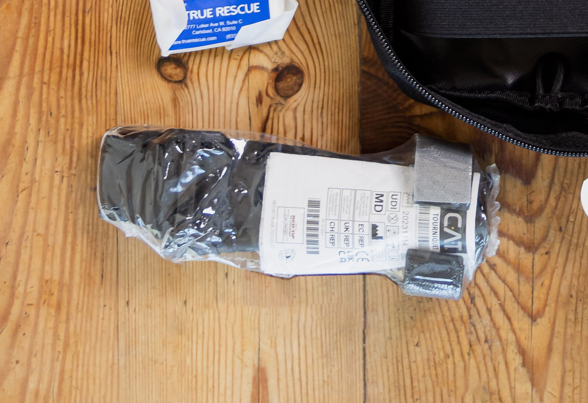 A first aid kit is sitting on a wooden table.