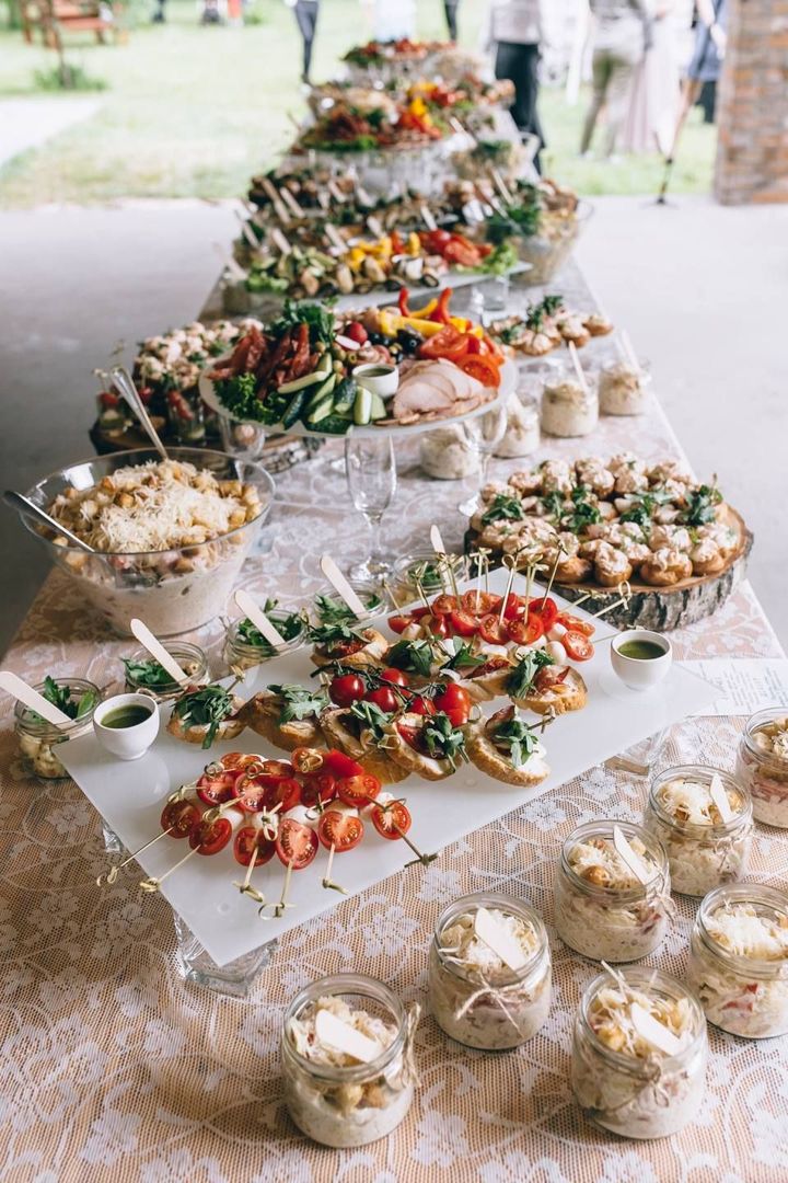 A long buffet table filled with lots of food and drinks.