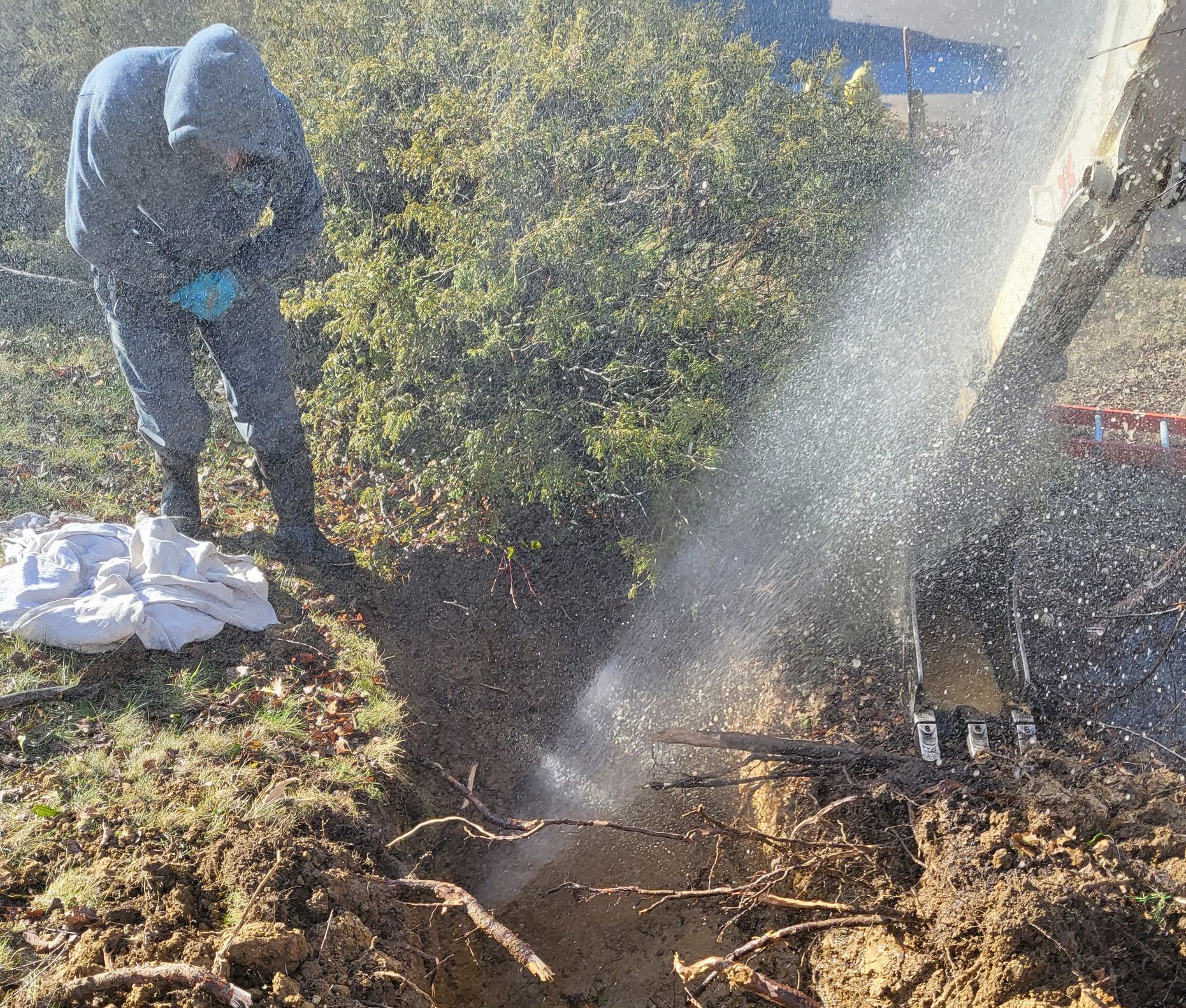 A man is digging a hole in the ground with a shovel.