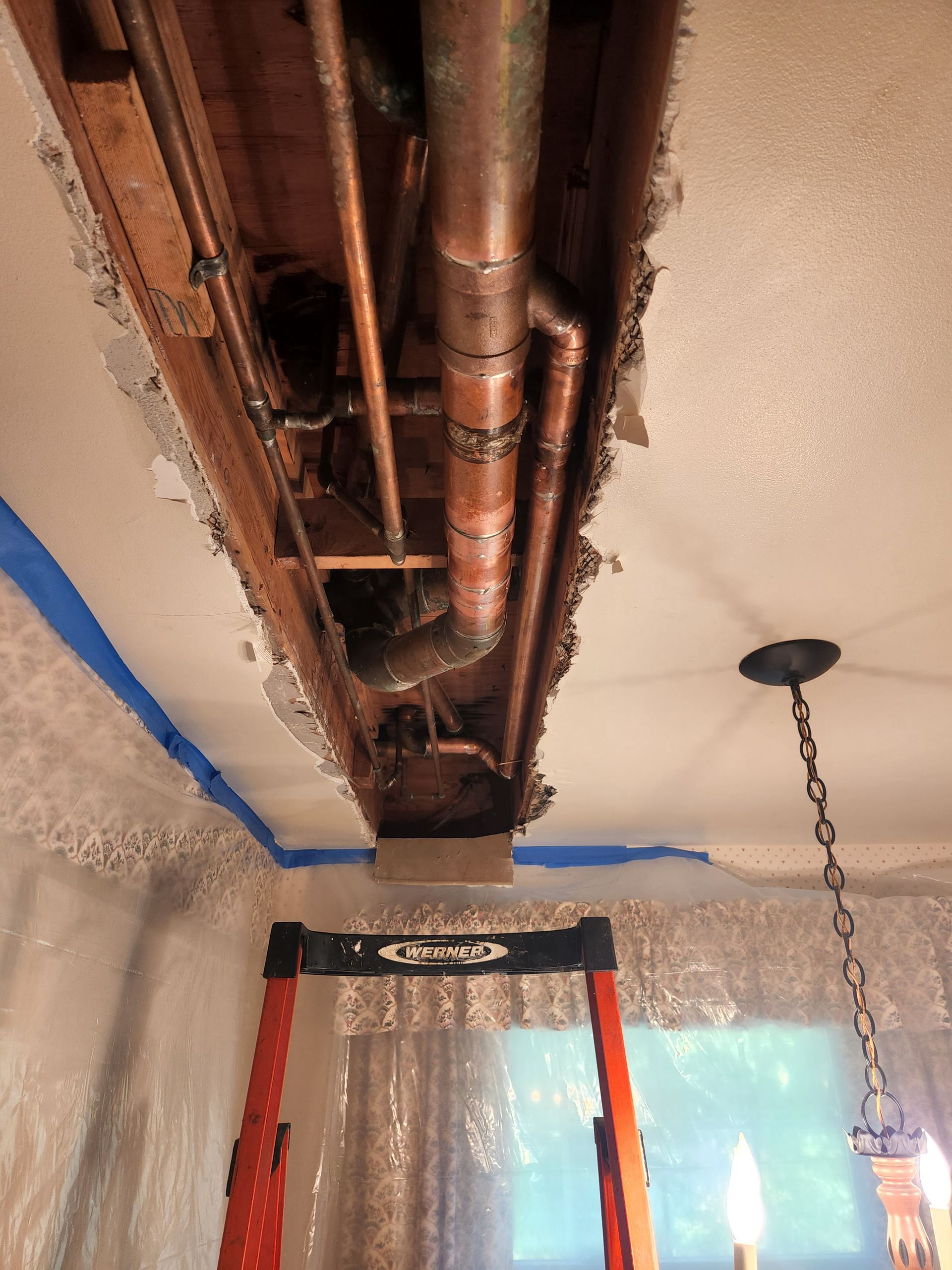 a plumber is working under a sink in a kitchen