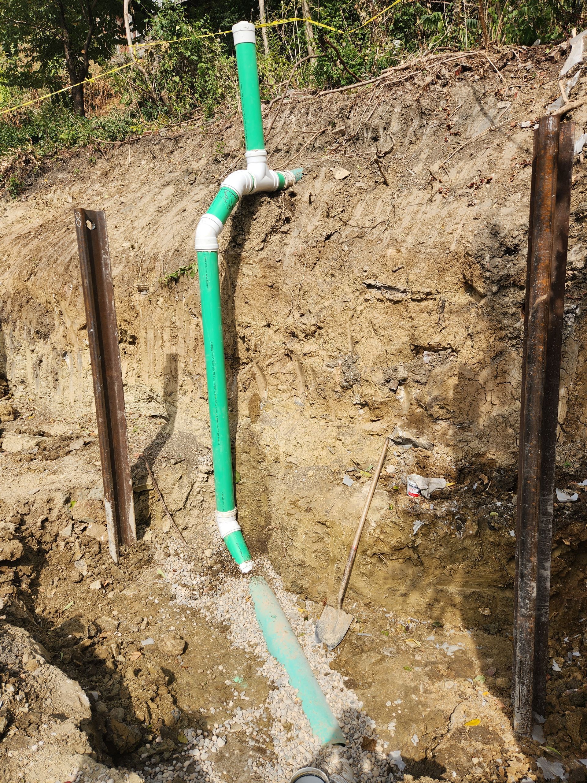 Construction site with newly installed water pipes buried underground.