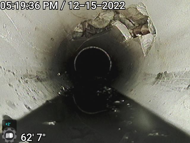 This break was identified and located with a sewer camera.  A fiberoptic line had been drilled through the sewer.