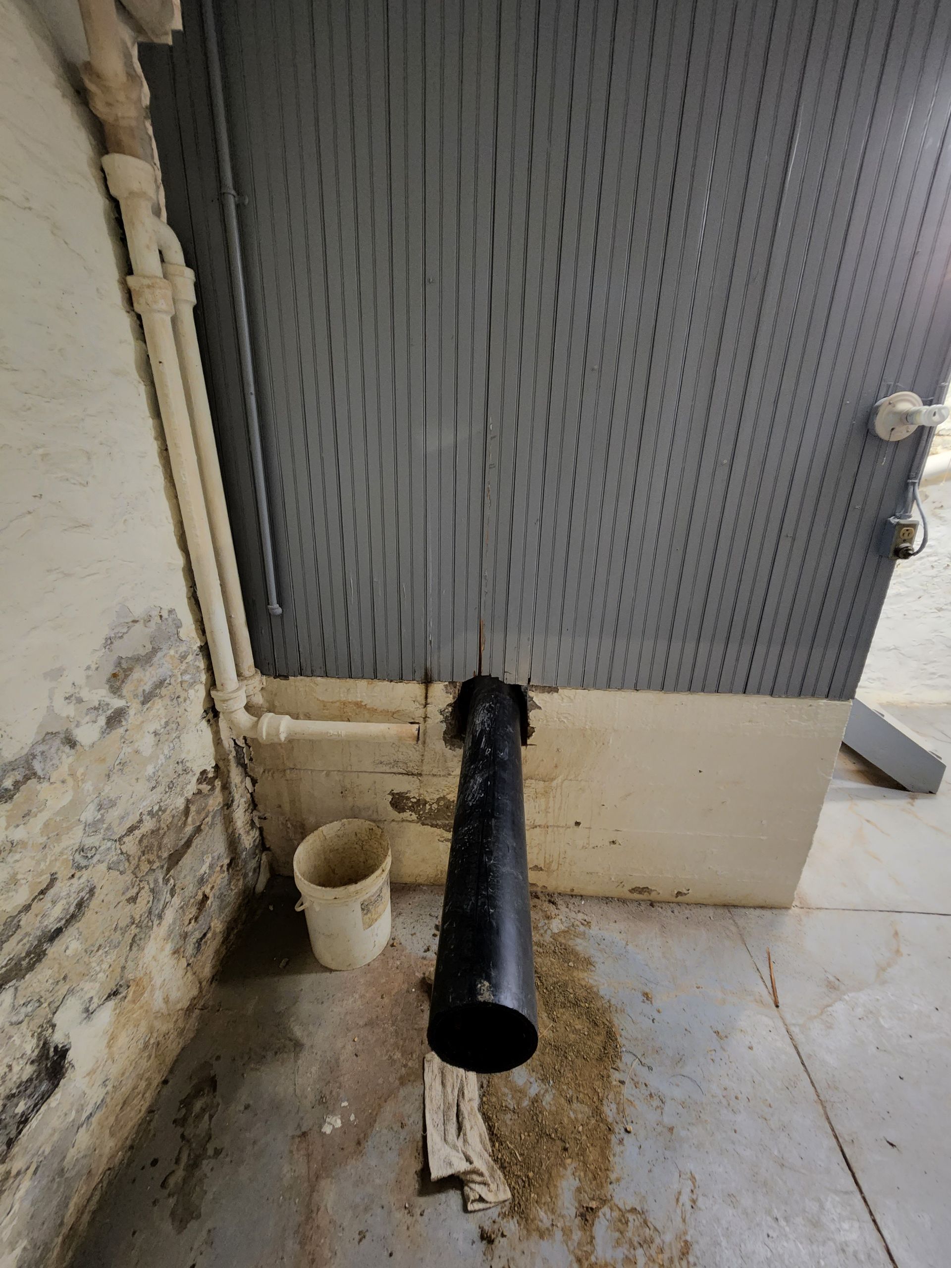 a person is fixing a shower head in a bathroom .