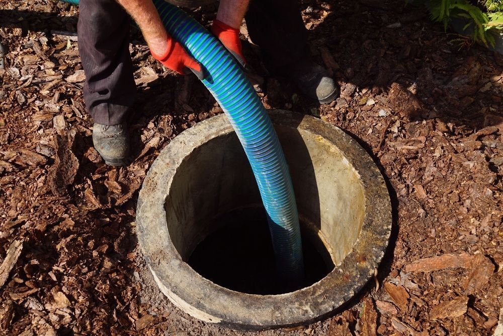 Septic tank pumping process with a pipe in the drainage pit.