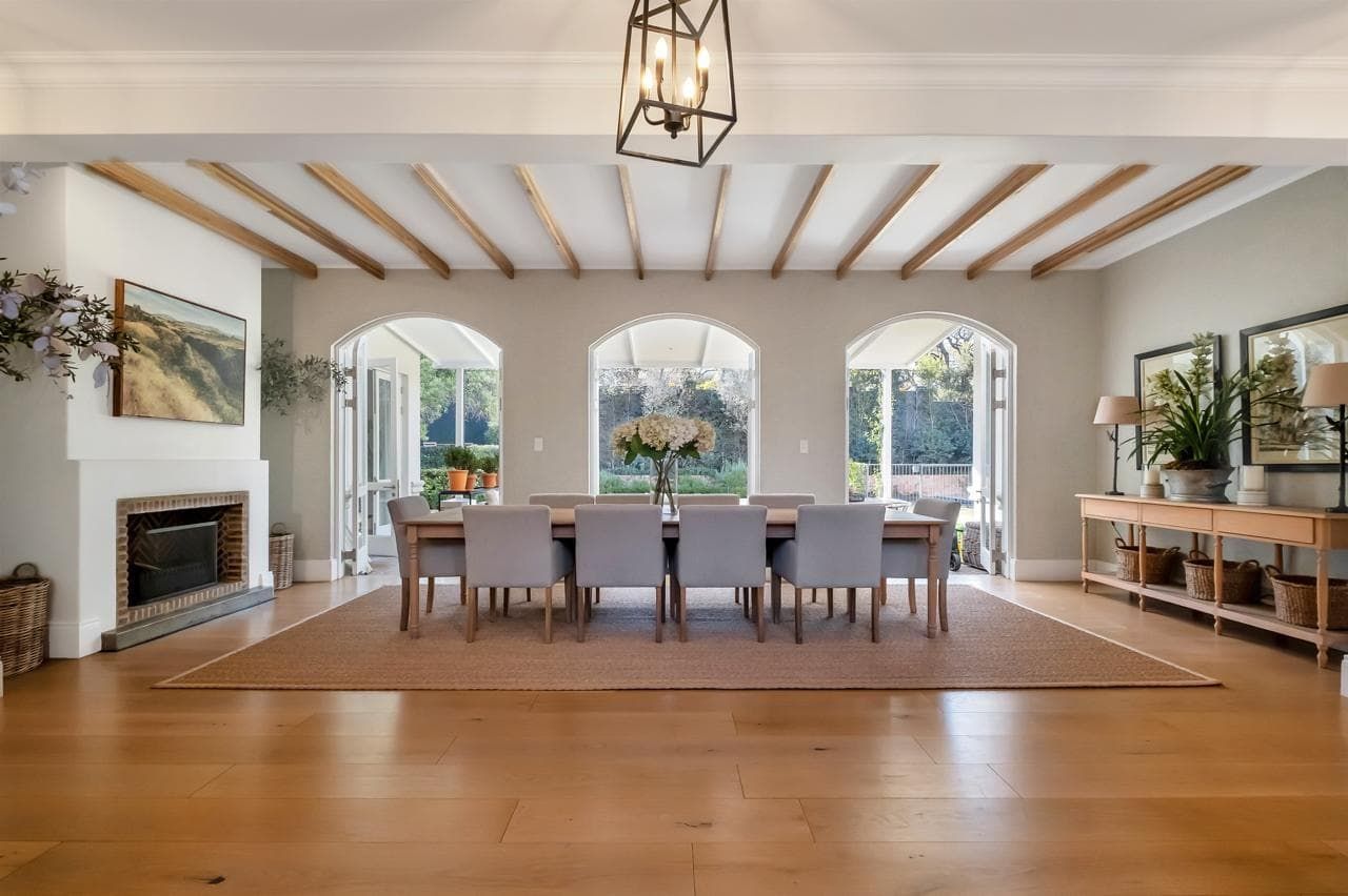 A large house with a swimming pool in front of it.