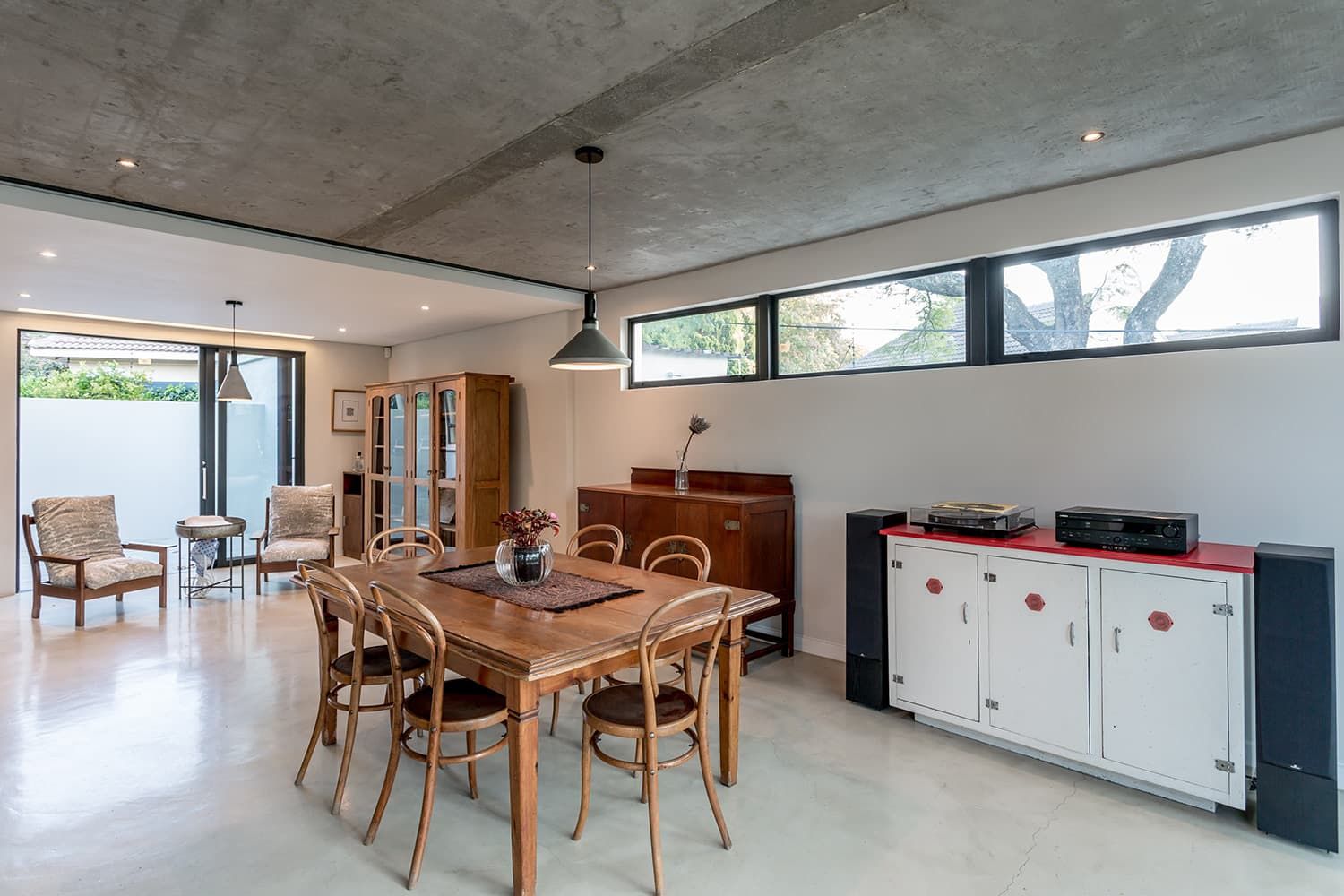 A large dining room with a wooden table and chairs.