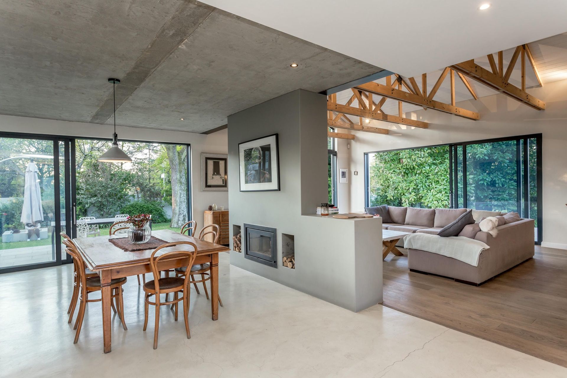 There is a table and chairs in the middle of the room.