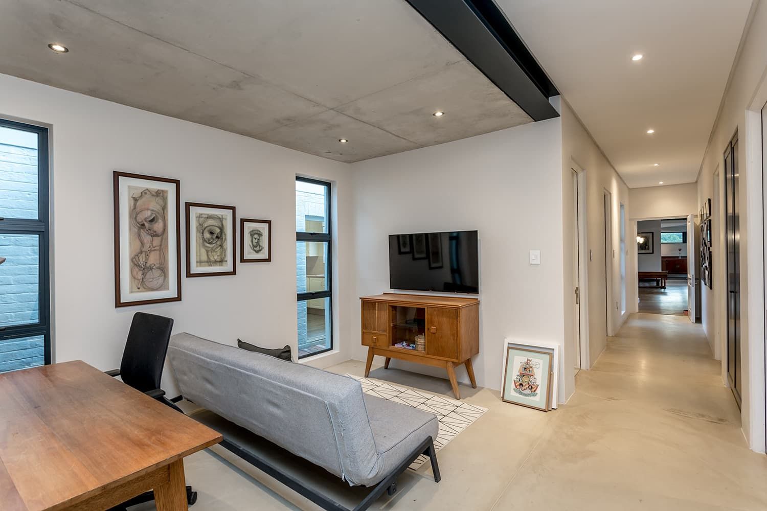 A living room with a couch , table , and television.