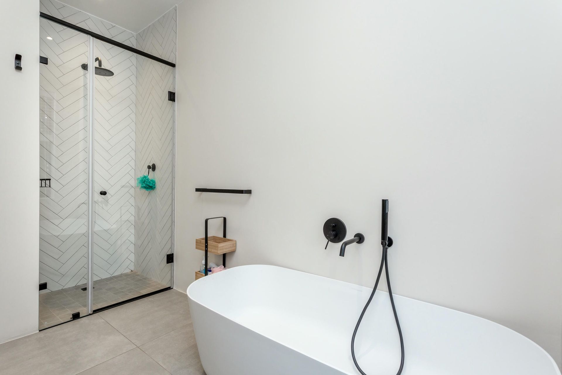 A bathroom with a bathtub and a shower.