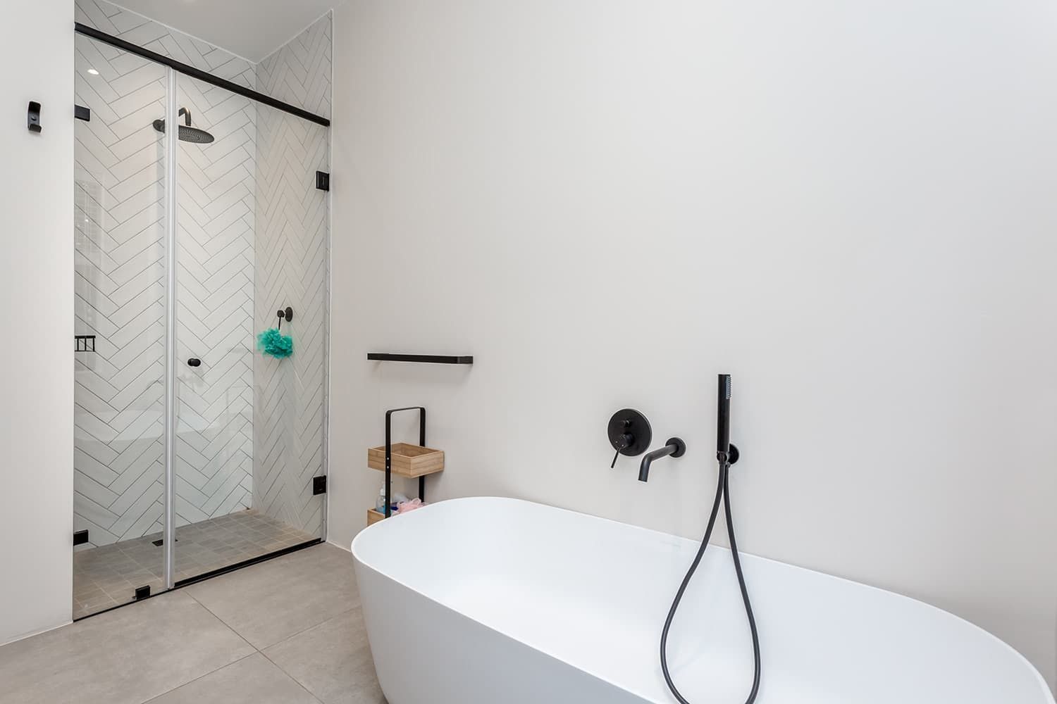 A bathroom with a bathtub and a shower stall.