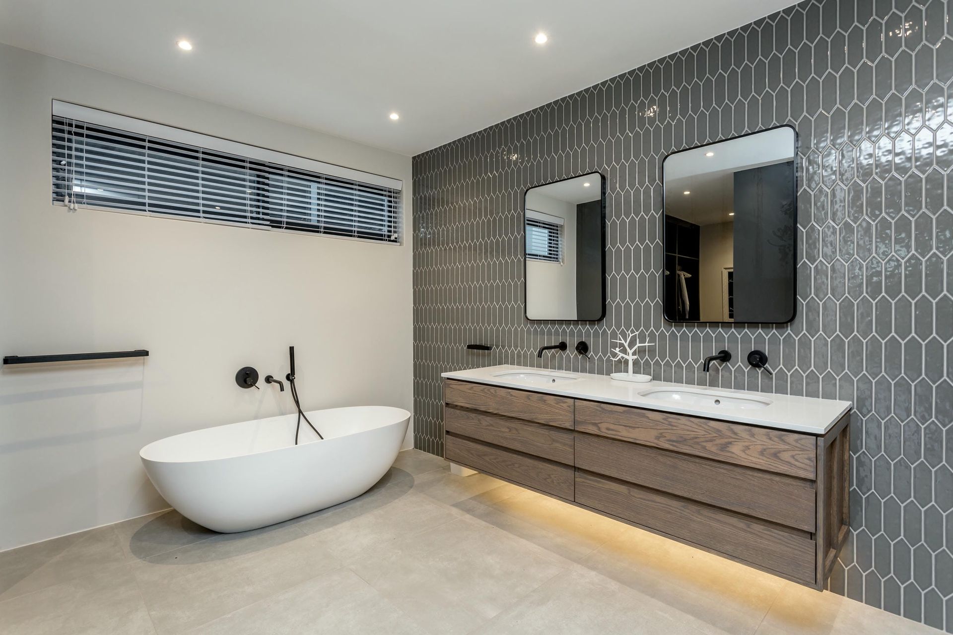 A bathroom with a bathtub and two sinks.